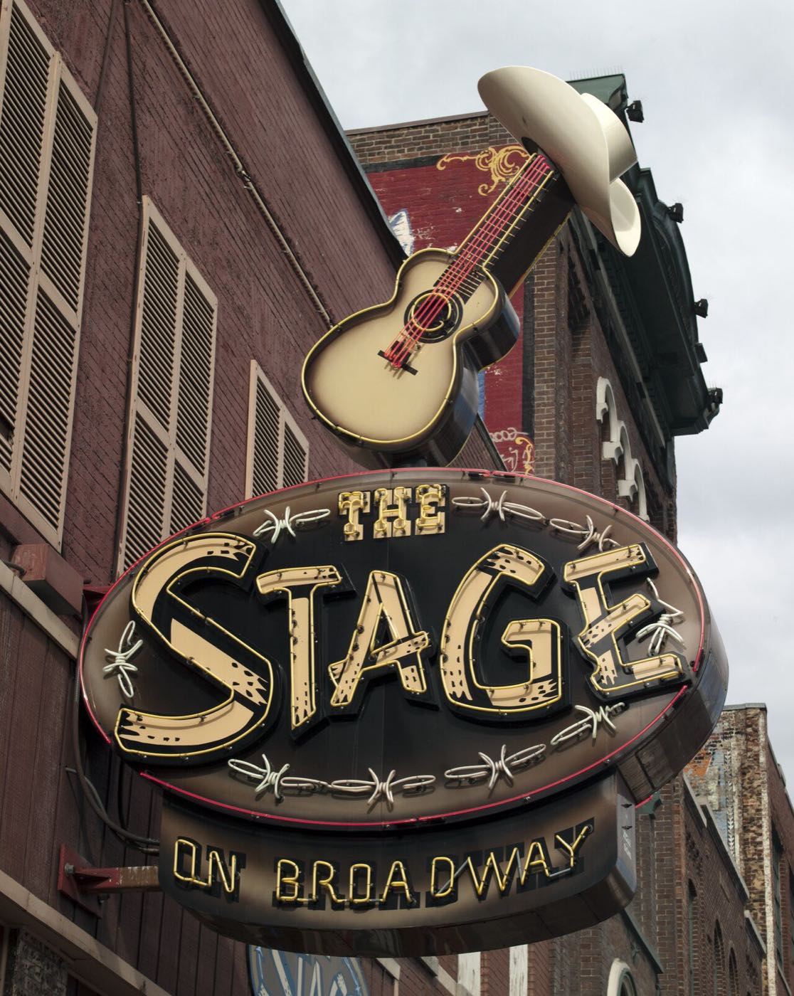 Neon guitar and cowboy hat sign of The Stage honky-tonk on Lower Broadway in Nashville.